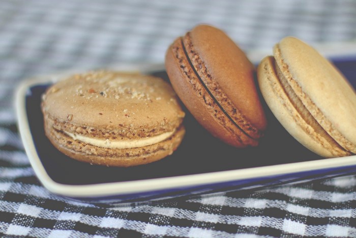 Three macarons on a blue plate