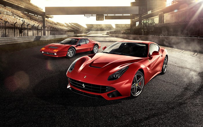 Two red Ferraris on a racetrack