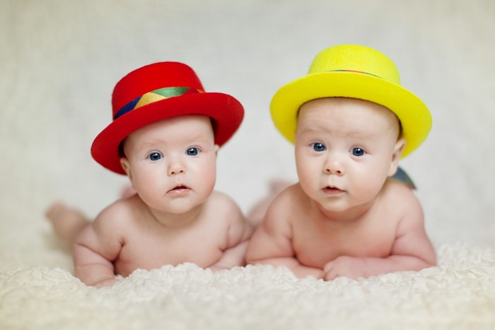 Two babies wearing hats