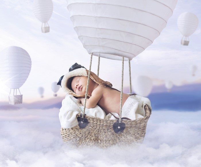 Infant sleeping in a hot air balloon basket