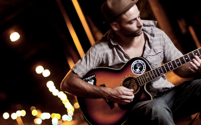 Man playing guitar at night