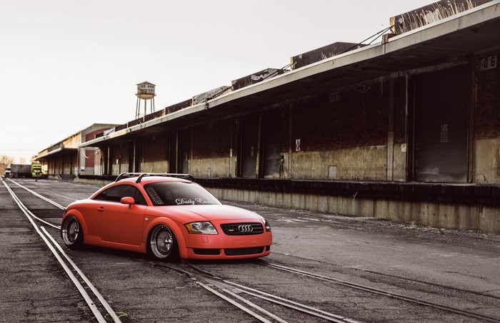 Orange Audi TT on Railroad Tracks