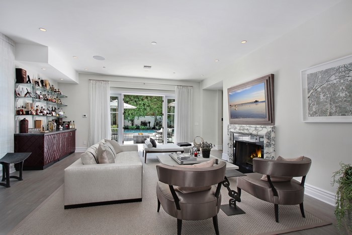Living room with fireplace, sofa, and bar