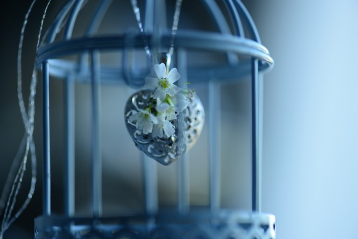 Heart pendant with flowers inside a birdcage