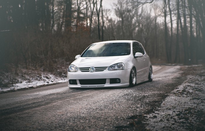 White Volkswagen Golf GTI on a Winter Road