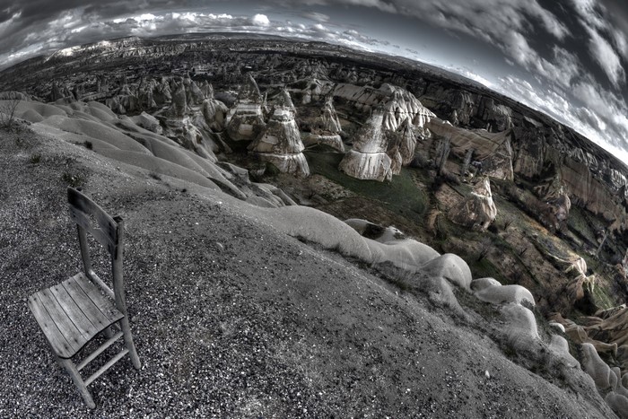 Chair overlooking rocky landscape with hoodoos