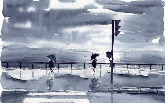 People with umbrellas on a rainy day by the sea