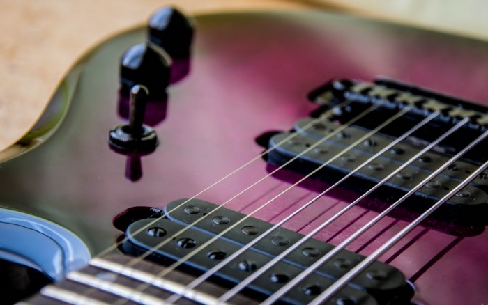 Close-up of a purple electric guitar