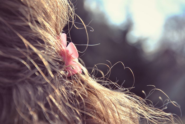 Close-up of blonde hair with pink clip