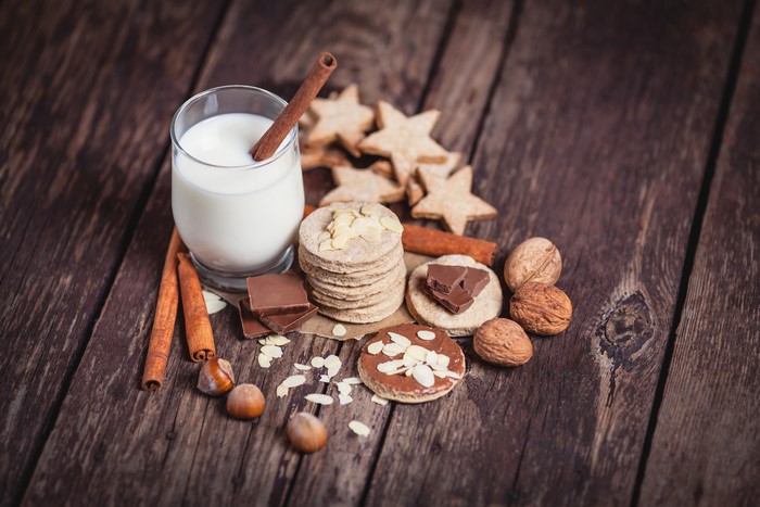 Cookies, Milk, Cinnamon, Nuts, and Chocolate on Wood