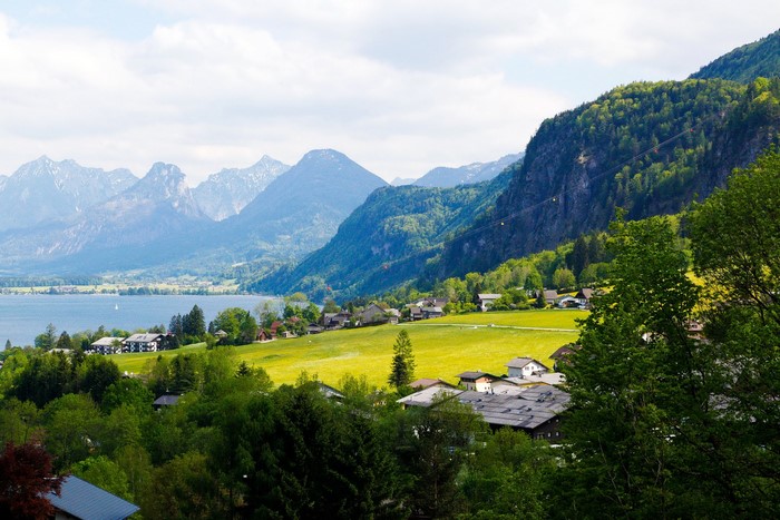 Houses by a lake with mountains in Austria