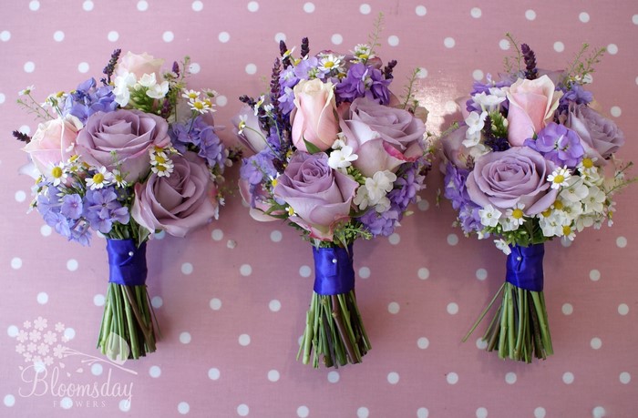 Three bouquets of roses, camomiles, and phlox