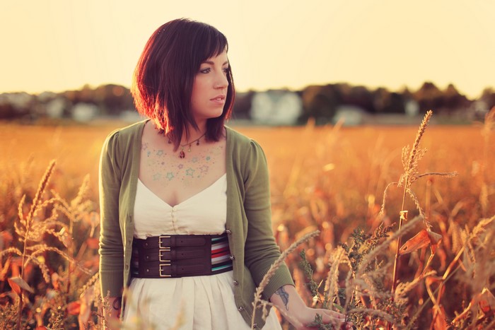 Woman in a field at sunset