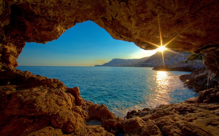 Cave overlooking the sea at sunset