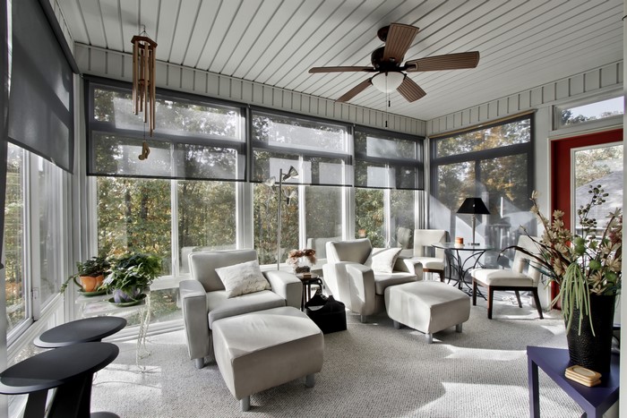 Sunroom with armchairs and large windows