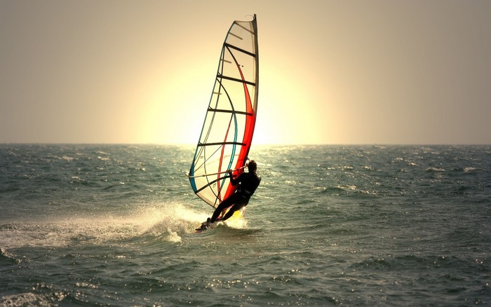 Windsurfer on the sea at sunset