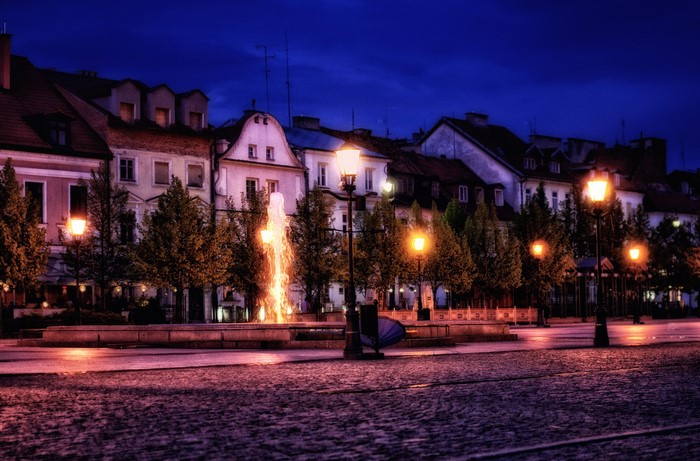 Street lights and fountain in Plock, Poland at night