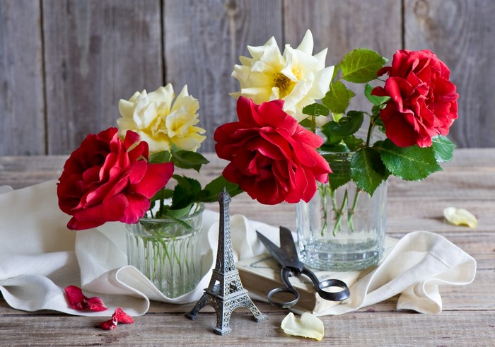 Roses in glass vases with Eiffel Tower miniature