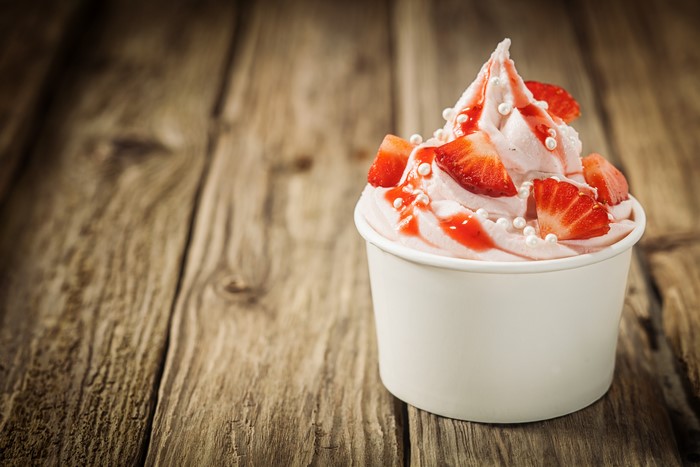 Strawberry ice cream with strawberries and syrup