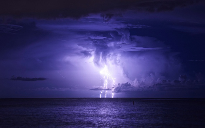 Lightning strikes over the ocean during a storm