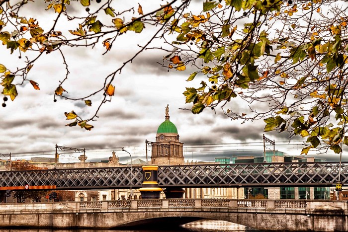 Autumn leaves frame Dublin bridge and Custom House