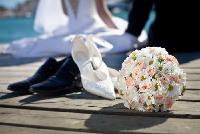 Wedding shoes and bouquet on a dock