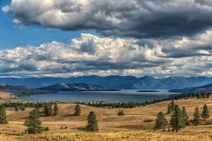 Lake and Mountains Under Cloudy Sky