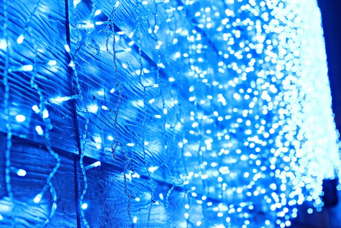 Blue fairy lights on a wooden surface