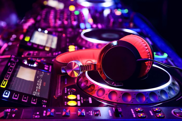 DJ headphones on a mixer with colorful lights