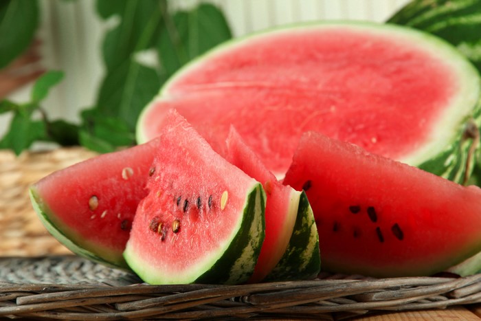 Watermelon slices on a woven mat