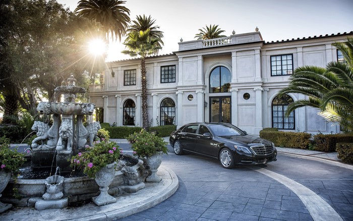 Black Mercedes-Benz S-Class Maybach in front of a mansion