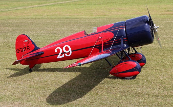 Red and blue vintage airplane with number 29