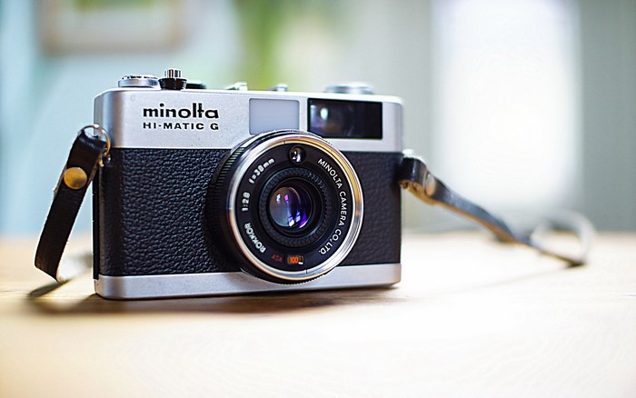 Minolta Hi-Matic G retro camera with strap