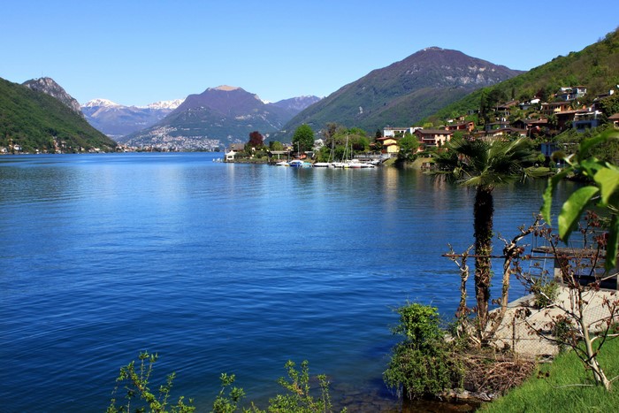 Lake Lugano with mountains and houses in Brusino Arsizio, Switzerland