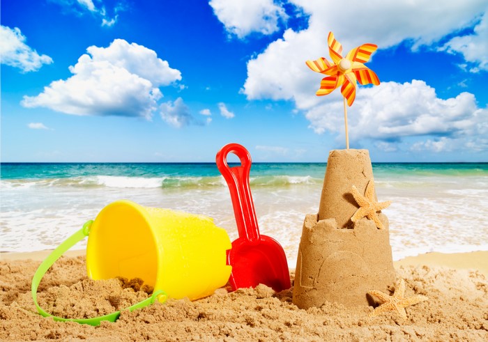 Beach toys and sandcastle on a sunny day
