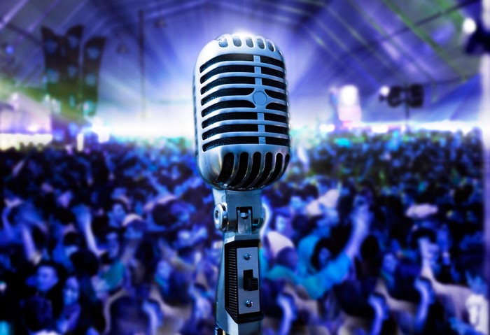 Retro microphone in front of a concert crowd
