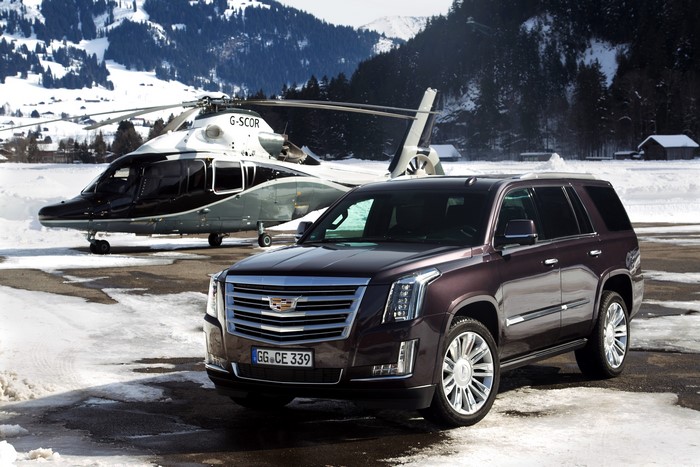 Cadillac Escalade and Helicopter in Snow