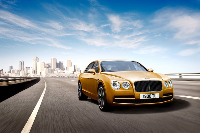 Yellow Bentley Flying Spur on a City Road