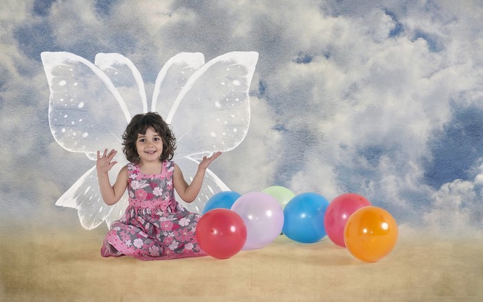 Girl with butterfly wings and balloons