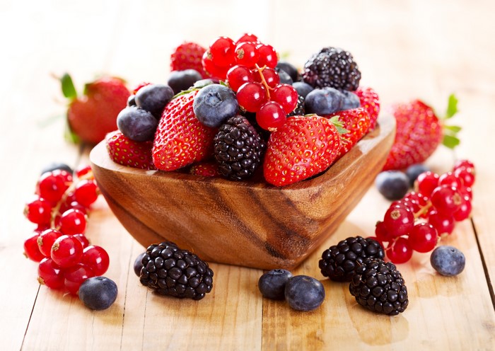 Bowl of fresh berries: strawberries, blueberries, blackberries, and currants