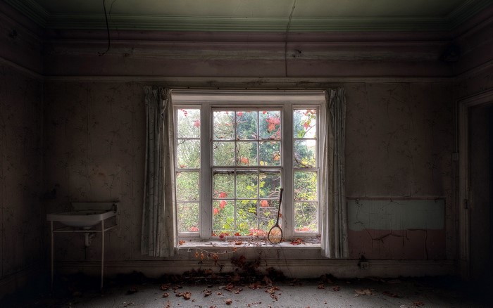 Abandoned room with a large window and sink