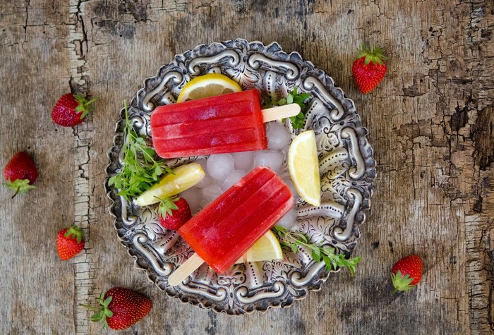 Strawberry lemon popsicles on a decorative plate