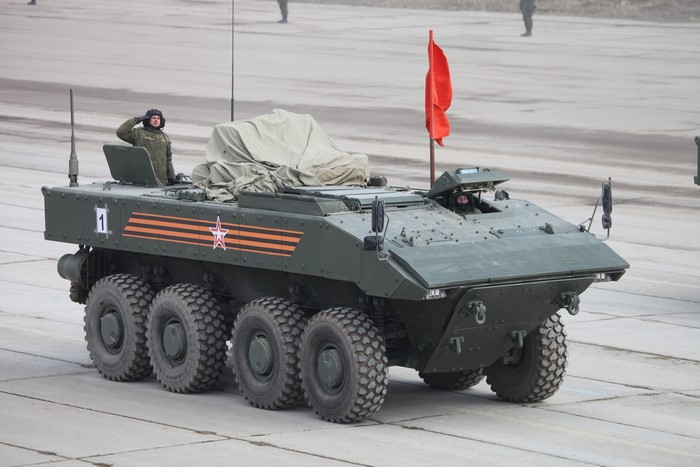 Russian Bumerang APC with soldiers and red flag
