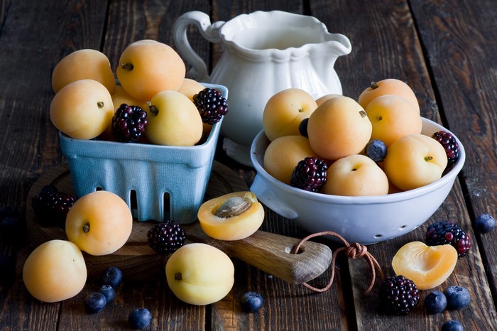 Apricots, Blackberries, and Blueberries in bowls with a pitcher