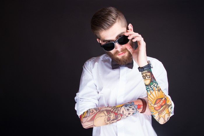 Man with beard, sunglasses, and tattoos