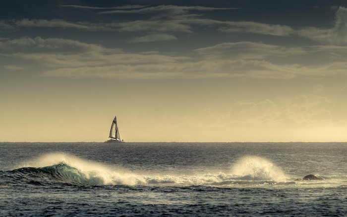 Sailboat on the ocean with waves