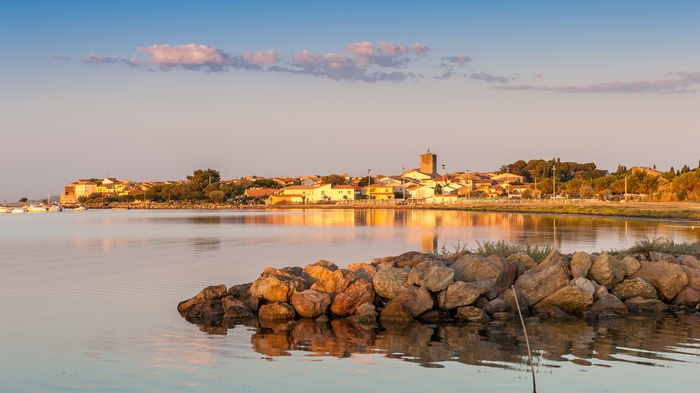Coastal town with a church tower at sunset