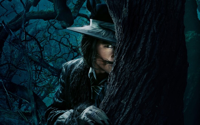 The Mad Hatter from Alice in Wonderland peeking from behind a tree
