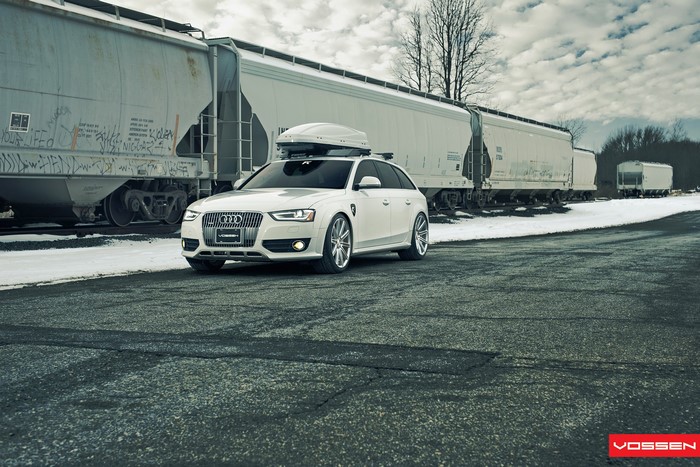 White Audi Allroad with Vossen Wheels and Cargo Box near Train