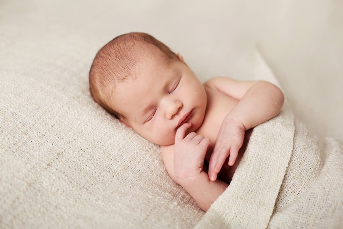Newborn baby sleeping on a blanket